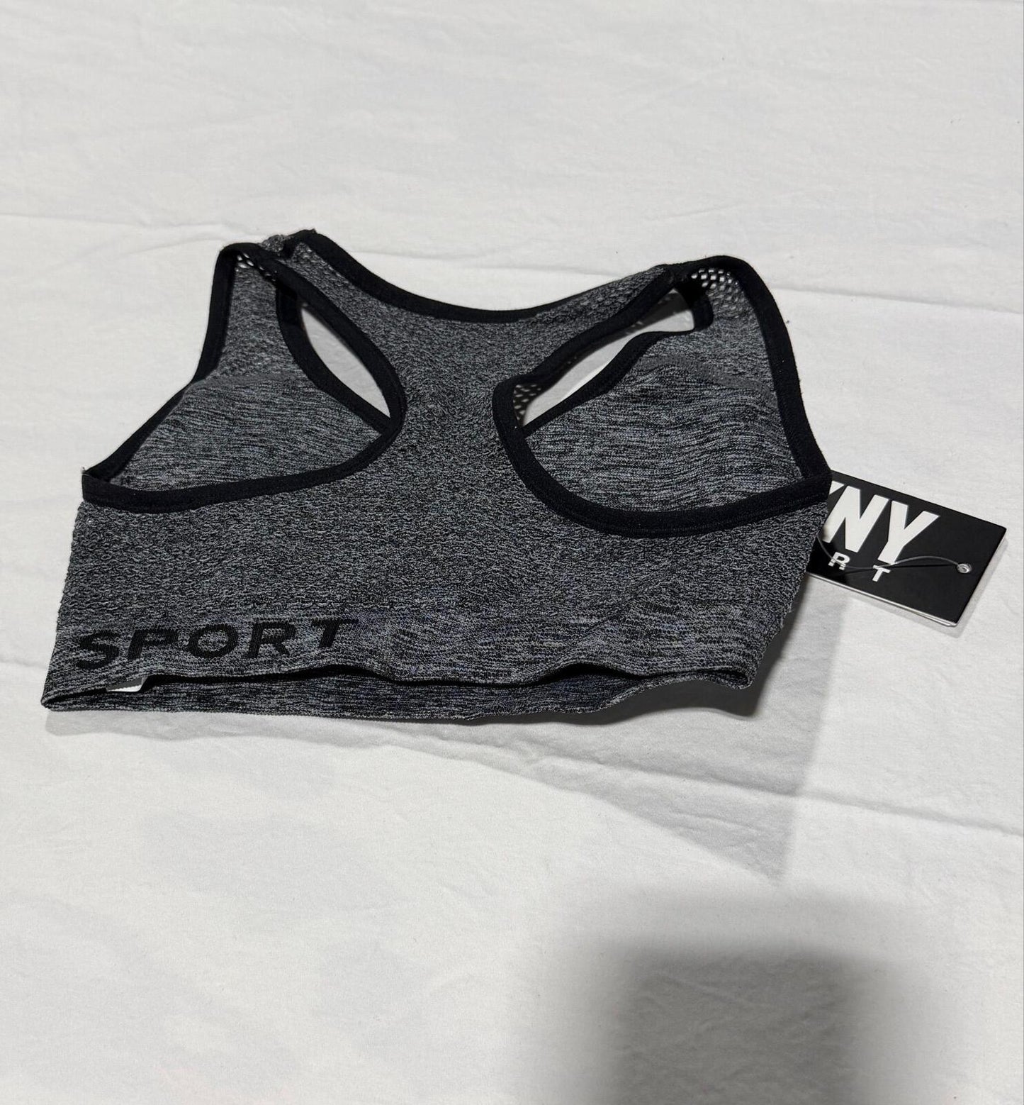 DKNY Sport Medium Impact Seamless Mesh-Back Sports Bra in a heathered grey and black colorway.