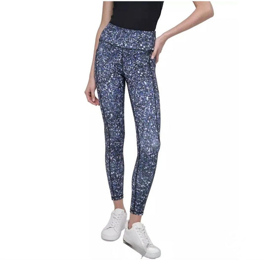 DKNY Sport High-Waist 7/8 Length Tights in a vibrant, multi-colored splatter or "galaxy" print.