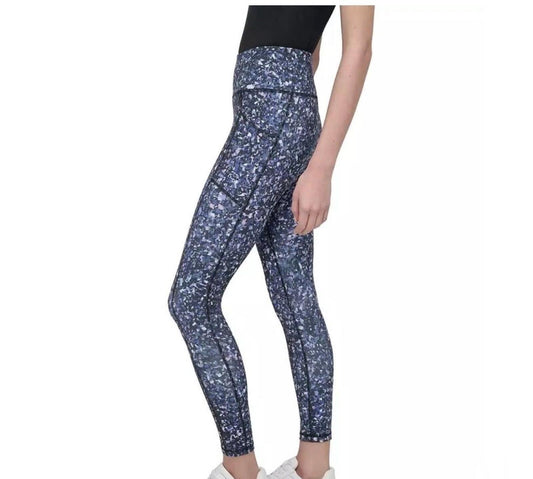 DKNY Sport High-Waist 7/8 Length Tights in a vibrant, multi-colored splatter or "galaxy" print.