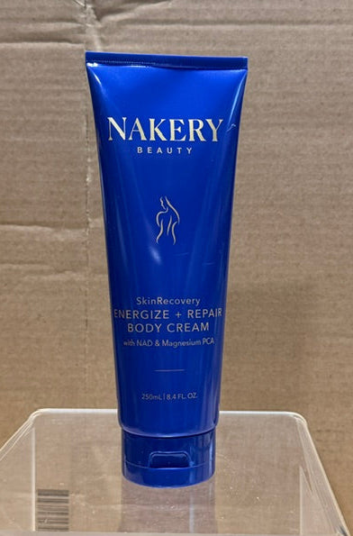 Front view of Nakery SkinRecovery Energize + Repair Body Cream in blue tube with gold lettering.